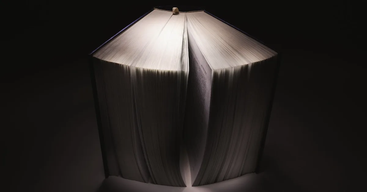 A thick open book with worn pages, illustrating a close reading of a novel.