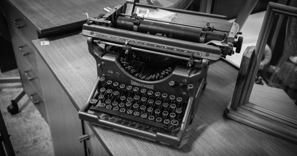 A vintage typewriter on a desk, illustrating a profile of a mid-century fiction writer.